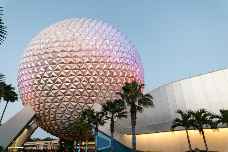 A luminous geometric dome shining against a serene sunset backdrop.