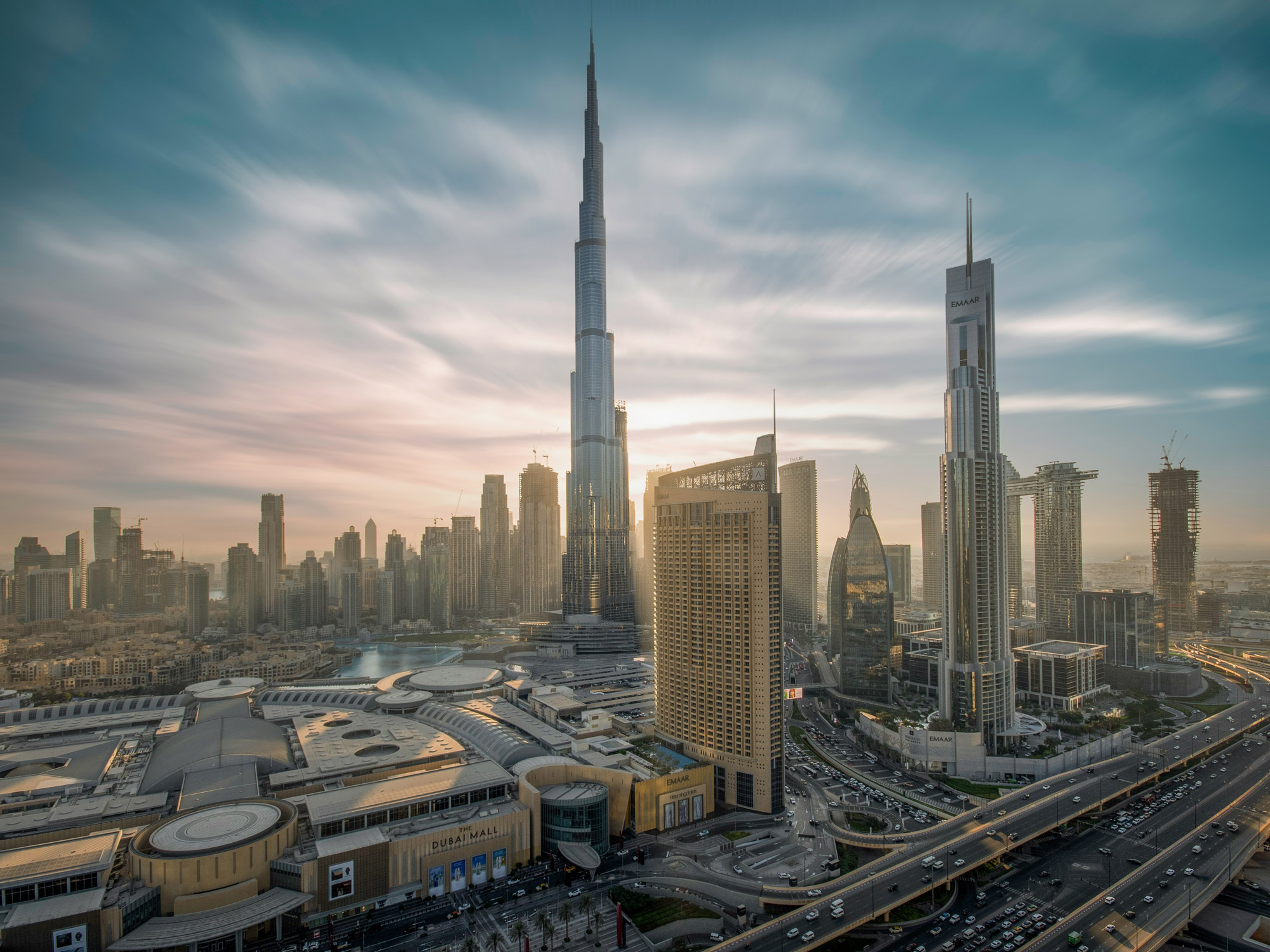 Tall buildings shining in the warm glow of a golden sunset.