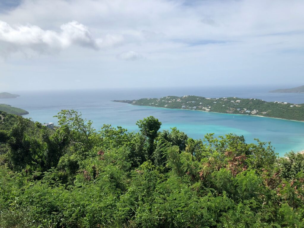 Aerial view of tropical coastline with turquoise ocean water and lush green islands.